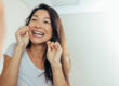 A woman flosses and wonders how to prevent tooth decay