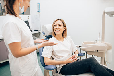 Apexogenesis a dentist talks to a woman about apexogenesis and root canal treatment in webster tx