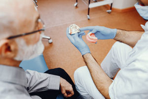 dentist talking to patient about dentures