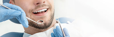 man being treated for emergency dental services