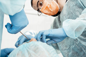 a patient receives oral surgery