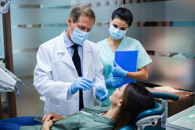 a woman tells her dentist i have a dental emergency
