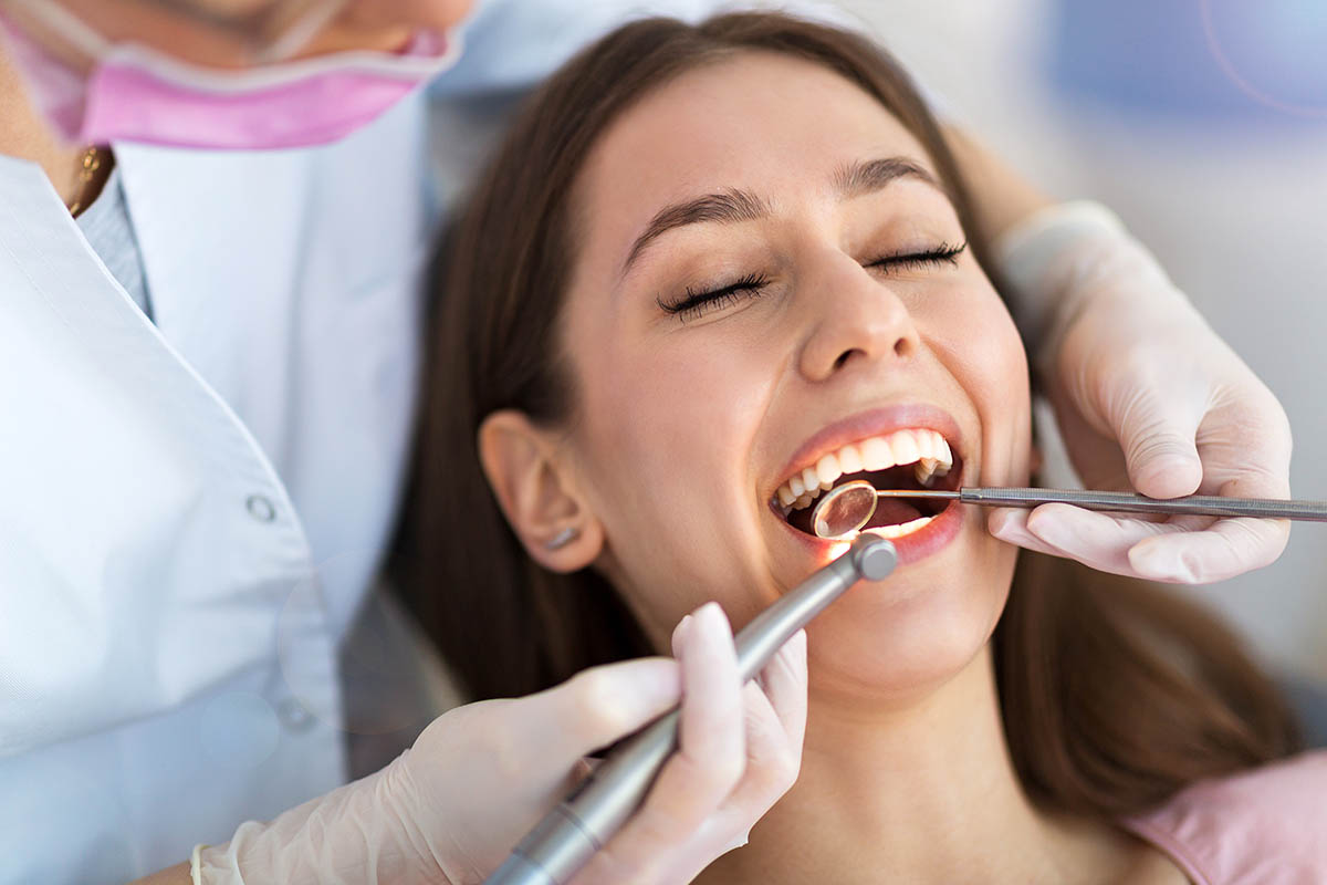 a woman learns about saturday dental appointments from her dentist