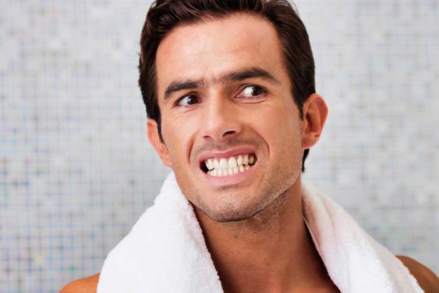 2-Understanding-the-Causes-of-Receding-Gums man notices that his gums are receding