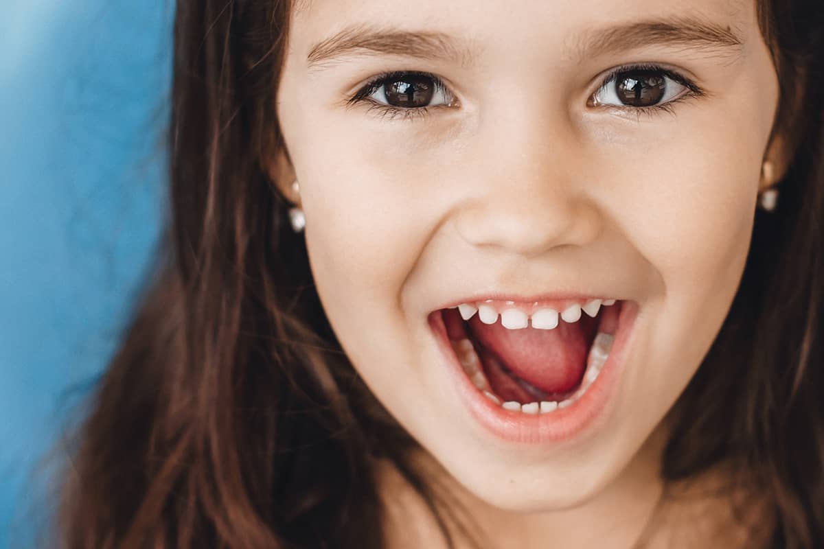 cavity prevention (1) Girl shows off cavity prevention.