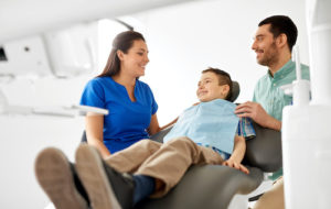 doctor prepares young man for dental bonding 