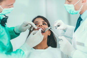 doctors prepare woman for a tooth extraction