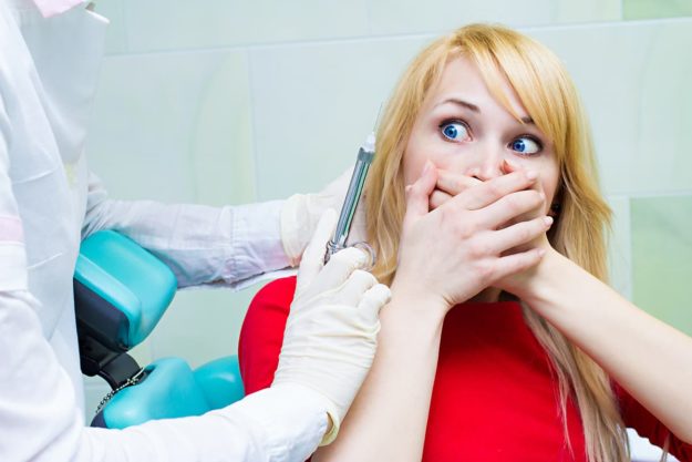 woman struggles with her dental anxiety