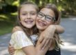 two girls show their smile with braces