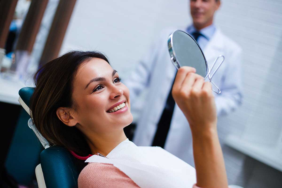 woman smiling after receiving a fluoride treatment